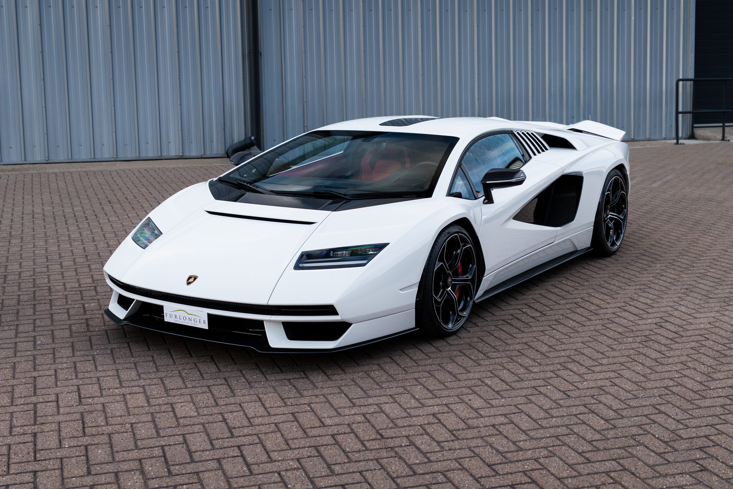 White Lamborghini Countach LPI 800-4 from the front three-quarter angle, with black wheels, red brake calipers and a Furlonger Specialist Cars plate.