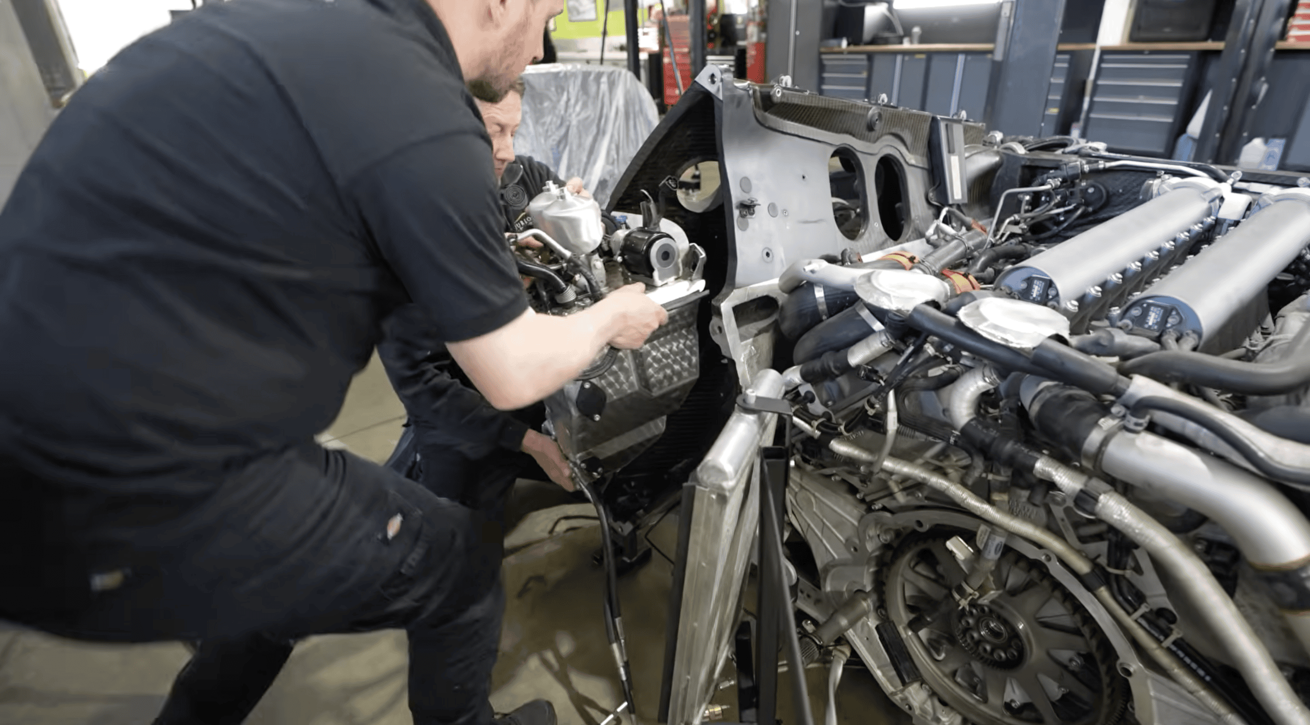 Furlonger fitting a reconditioned gearbox oil and cooler tank to Mark McCann's Veyron